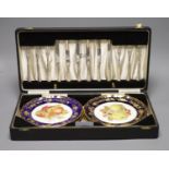 A cased dessert service containing six gilt and fruit decorated plates and a set of knives and