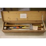 An early 20th century pine cased croquet set