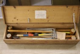 An early 20th century pine cased croquet set