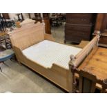 A 19th century Continental pine bed frame and mattress, width 130cm, length 190cm