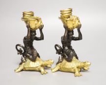 Two bronze and gilt metal candlesticks, modelled as Triton riding a tortoise, height 16.5cm