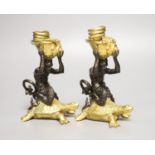 Two bronze and gilt metal candlesticks, modelled as Triton riding a tortoise, height 16.5cm