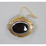 A Victorian pierced yellow metal and banded agate set oval mourning brooch, with plaited hair en