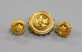 A Victorian yellow metal circular mourning brooch with foliate motif, 28mm and a pair of matching