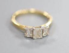 An emerald cut three-stone diamond ring, 18ct yellow and white gold setting, original box and