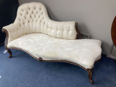 A Victorian carved rosewood chaise longue with button shaped back and serpentine seat raised on