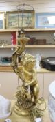 A large moulded gilt putti table lamp, height 70cm excl. light fitting