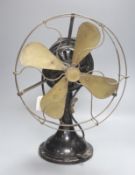 A vintage cast iron and brass propeller desk fan, height 45cm