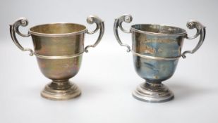 A pair of late Victorian silver two handled pedestal trophy cups, James Deakin & Sons, Sheffield