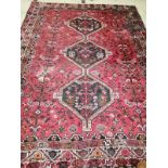 A Hamadan red ground carpet, 290 x 216cm