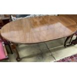 A 1930's mahogany oval topped extending dining table, one spare leaf, 174cm extended, width 106cm,