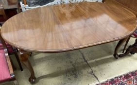 A 1930's mahogany oval topped extending dining table, one spare leaf, 174cm extended, width 106cm,