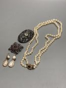 A double strand graduated cultured pearl necklace, with 9ct, garnet and cultured pearl cluster set