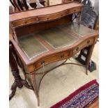 A reproduction yew serpentine writing table, width 92cm, depth 50cm, height 103cm