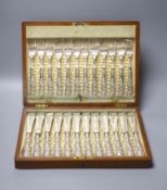An Edwardian cased set of twelve pairs of silver handled fish eaters, John Biggin, Sheffield,