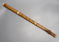 A three sectional Monzani flute with seven holes and a turned ivory cap and collars, stamped