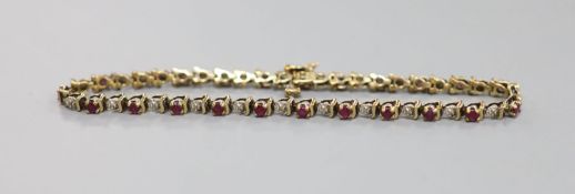 A modern 9ct gold, ruby and diamond chip set line bracelet, 20.3cm, gross 7.5 grams.