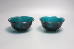 A pair of Chinese Beijing green glass bowls, Qianlong four character and of the period, diameter