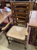 A set of eight 18th century style oak rush seat ladderback dining chairs, (two with arms)