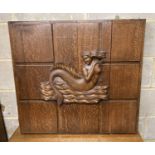 A mid 20th century rectangular oak panel carved with a mermaid formerly a cabinet door, width