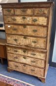An early 18th century banded walnut tallboy, with oak sides, fitted three small and six long drawers