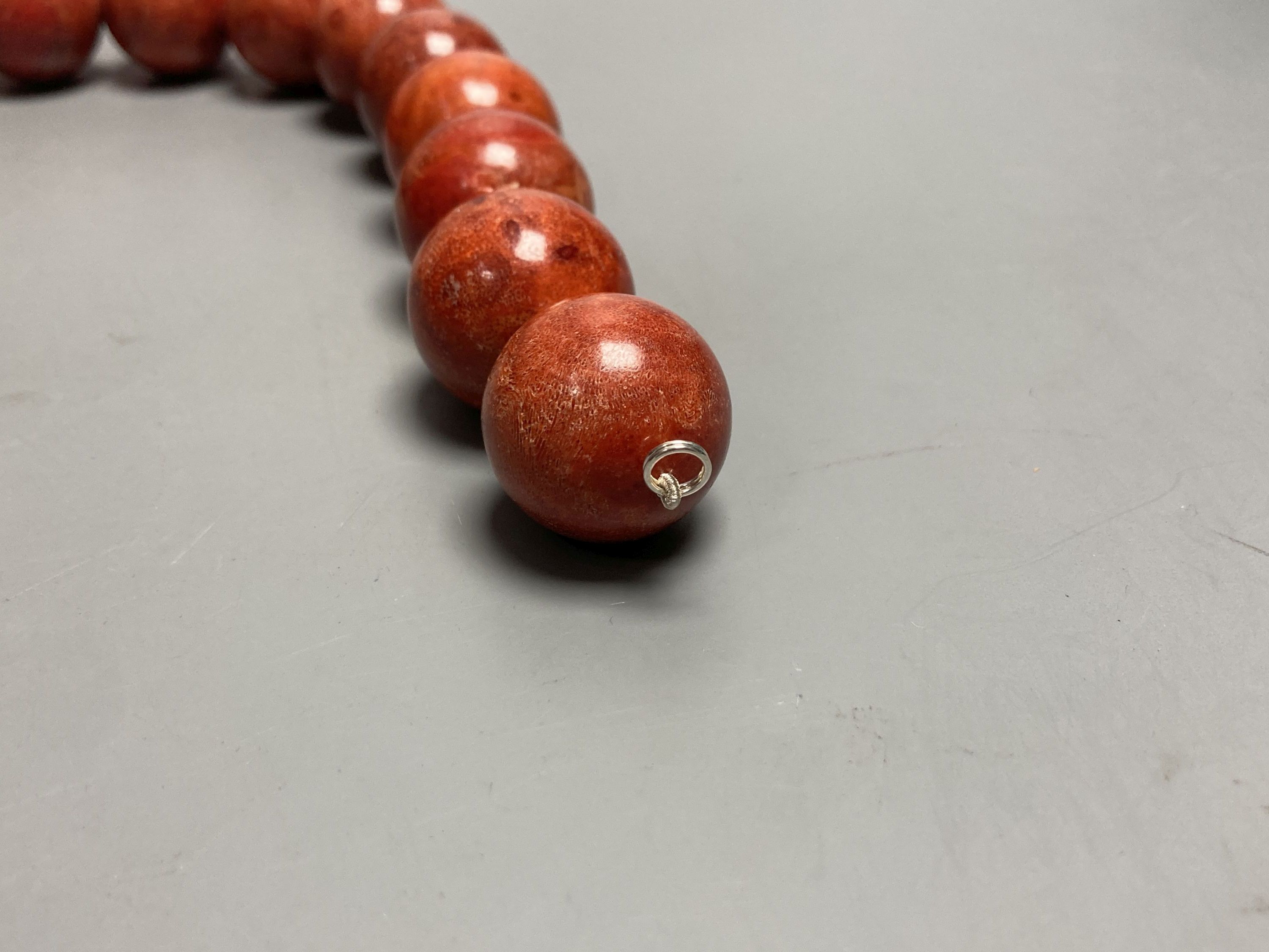A large single strand circular stained? coral bead necklace, no clasp, 43cm, gross 267 grams. - Image 3 of 3