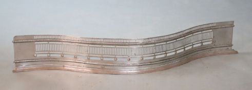 A George III style polished steel serpentine fender, W.107cmCONDITION: Slightly bent out of shape