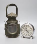 A green painted railway lantern, 30cm high, together with a French chrome cased alarm clock, the