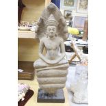 A large stone figure in the style of a Cambodian Buddha, on stand, height 68cm