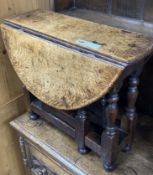 A 19th century miniature oak drop leaf gateleg table with turned supports, height 48cm, top 62 x