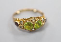 A George V 9ct gold, peridot, seed pearl and garnet set dress ring, in the Suffragette colours, size