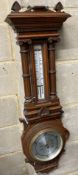 An Edwardian carved oak aneroid barometer and thermometer, height 80cm