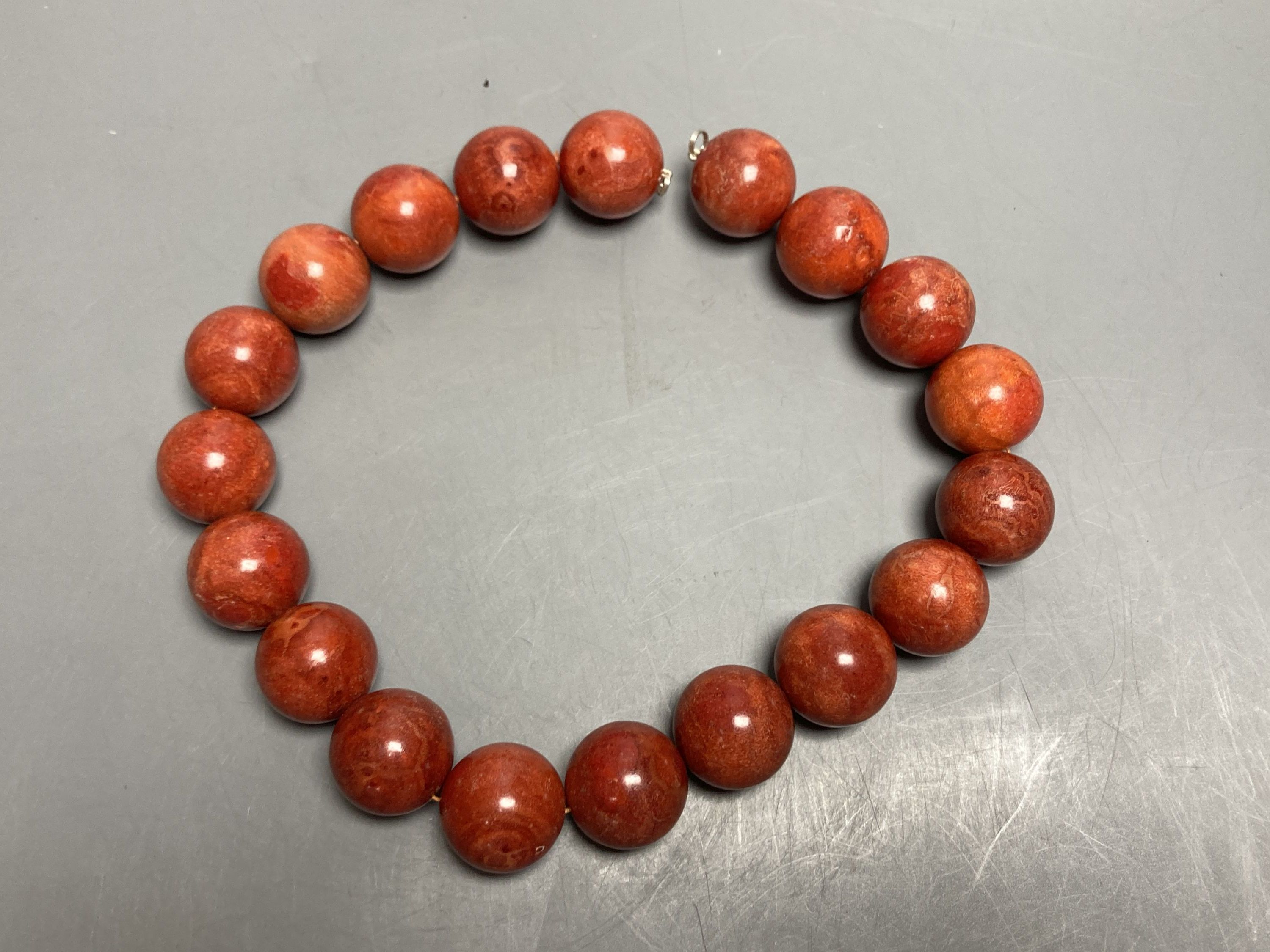 A large single strand circular stained? coral bead necklace, no clasp, 43cm, gross 267 grams. - Image 2 of 3