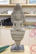 A large Cambodian stone figure of Buddha, on stand, height 71cm