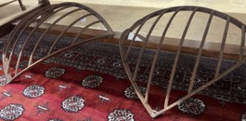 A pair of wrought iron corner stable mangers, each 80cm wide, height 76cm