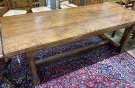 An 18th century style oak refectory dining table, length 214cm, depth 81cm, height 76cm