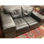 A pair of contemporary black leather two seater sofas, length 166cm, depth 92cm, height 70cm