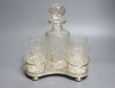 A decanter and four glasses, on plated stand, width 24cm