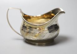 A George III silver cream jug, with engraved monogram, London, 1811, height 72mm, 92 grams.