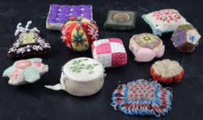 Twelve assorted 19th century fabric pin cushions including Irish silkwork, velvet and