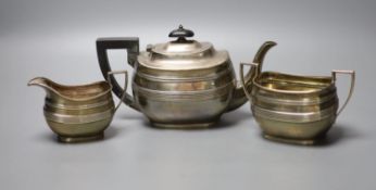 A George V reeded silver oval three piece tea set, George Howson, London, 1910, gross 16oz.