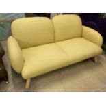 A contemporary pale yellow fabric two seater settee, length 160cm, depth 80cm, height 76cm