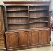A Victorian mahogany library bookcase, the open shelves over an enclosed four door base, length