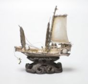 A Chinese white metal miniature model of a junk, 75mm, on wooden stand, in fitted box.