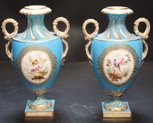 A pair of mid 19th century Coalport turquoise ground two handled vases, painted in Sévres style with