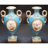 A pair of mid 19th century Coalport turquoise ground two handled vases, painted in Sévres style with