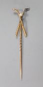An early 20th century yellow metal and seed pearl set 'crossed golf clubs' stick pin, 57mm, gross