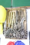 A quantity of cast bronze and brass model cannons, assorted carriage wheels and parts, 20th century,