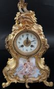 An early 20th century French gilt metal and porcelain eight day mantel clock, the arabic dial signed