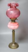 A Victorian brass and pink glass oil lamp, height 70cm